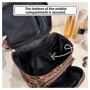 Detail view of leopard print cosmetic bag with fixed middle compartment and mesh pockets