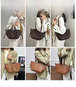 Detail view of large leather tote bag featuring pleated texture and side knot drawstring