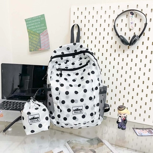 Macro detail of polka dot backpack set and drawstring bag on a study desk
