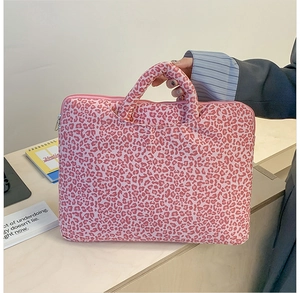 Detail of pink leopard print laptop tote bag featuring padded handles and metal zipper