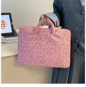 Detail of pink leopard print laptop bag with sturdy handles and smooth zipper closure