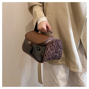 Detail of multi-texture Boston bag with leopard print, matte brown and black patent leather