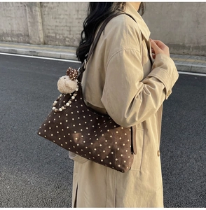 Brown polka dot crossbody bag with cute plush bear charm and beaded strap details