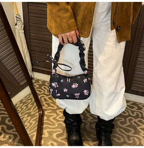 Floral canvas bag with pink rose patterns, drawstring ribbon details and ruched handle