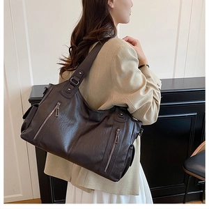 Detail view of the deep brown vintage tote bag featuring multiple zipper pockets and soft PU leather