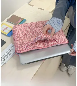 Detail of pink leopard print laptop sleeve showing padded fabric and top handle