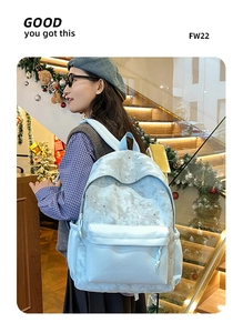Detail showing high-capacity light blue backpack with moon and star patterns for students