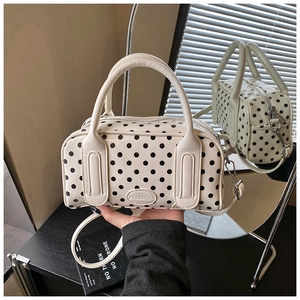Polka dot Boston handbag in cream white with black dots and a mirror reflection view