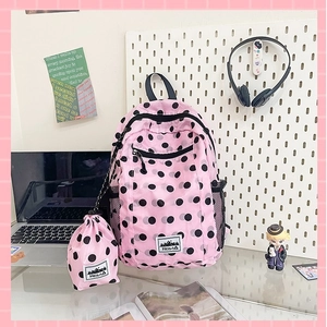 Pink polka dot backpack with matching storage bag and spacious minimalist schoolbag design