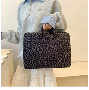 Detail of purple leopard print laptop tote bag with soft fabric and durable handles