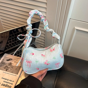 Floral light blue pleated shoulder bag with pink bows and floral patterns in daily setting