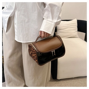 Detailed view of the double-layer makeup bag with leopard print and black patent leather