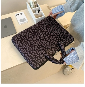 Macro detail of purple leopard print laptop sleeve featuring protective padded handles