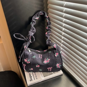Floral canvas shoulder bag with pink roses, bow patterns, and pleated black texture