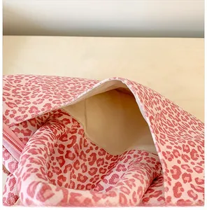 Close-up of pink leopard print tote bag interior featuring inner pocket and premium lining
