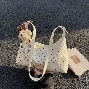 Chic cream dumpling bag with brown polka dots and cute plush dog pendant charm