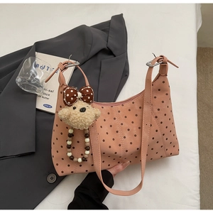 Pink polka dot crescent shoulder bag with cute plush bear charm and stylish design