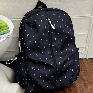 Minimalist black backpack with white star and music note patterns in a casual style