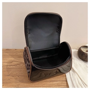 Detail of double-layer PU leather toiletry bag with leopard print and spacious interior