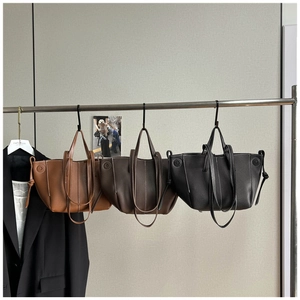 Minimalist large capacity tote bag with contrast stitching in brown and black colors