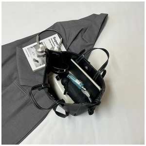 Interior view of black tote bag showing spacious capacity for books and daily essentials