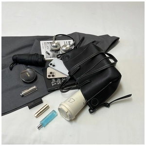 Spacious black pleated tote bag showing storage for daily essentials and cosmetics