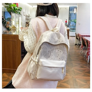 Detail of printed starry moon pattern on durable ivory nylon backpack with drawstring side pockets