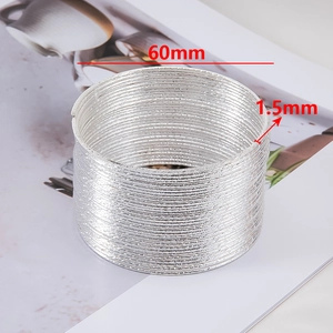Detailed view of 60mm multi-layered textured steel coil rings with 1.5mm wire thickness