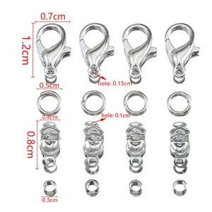 Macro shot of jewelry DIY set featuring silver lobster clasps, jump rings and crimp beads