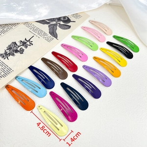 Set of 4.8cm colorful metal snap hair clips in multiple pastel shades on a white fabric