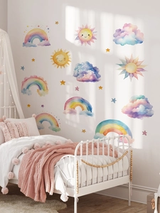 Detailed view of hand-painted rainbow wall stickers in a cozy nursery room setting