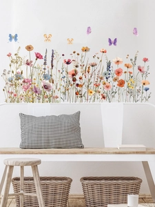 Détail de stickers muraux floraux avec fleurs sauvages et papillons sur mur blanc