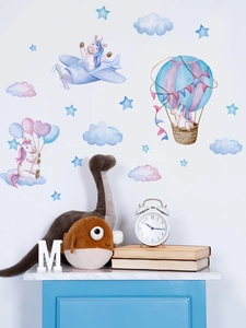 Detail of unicorn wall stickers with hot air balloons and clouds in a nursery room decor
