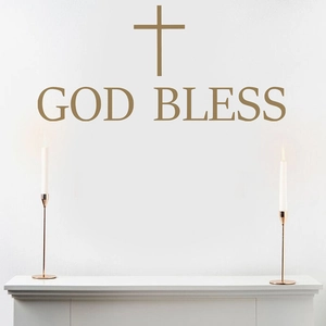 Golden God Bless wall sticker with cross icon on white wall above fireplace