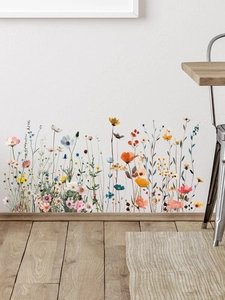 Détail de stickers muraux fleurs sauvages colorées avec des marguerites sur un mur blanc