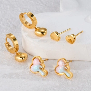 Three-piece gold heart and glitter cloud stud earring set on a white stone base