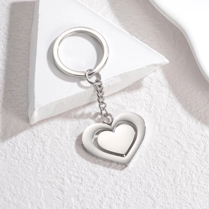Polished stainless steel double heart spinning keychain with geometric display stand