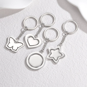 Set of four rotating stainless steel keychains in butterfly, heart, round and star shapes