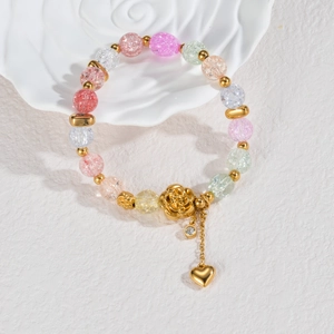 Colorful crystal bead bracelet with golden rose and heart tassel charms on white decor