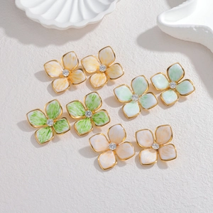Detailed view of 18K gold-plated petal earrings with colorful enamel and center crystals