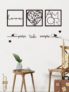 Detail view of minimalist love and amor wall stickers on a clean white living room wall