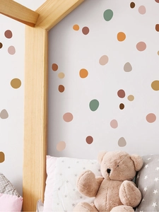 Detail of colorful irregular polka dot wall stickers in a cozy Nordic children's bedroom