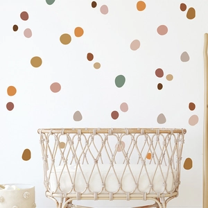Close-up of bohemian style earth-toned dot wall stickers in a cozy nursery setting