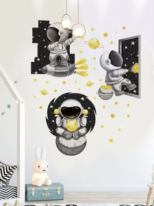 Detail of cartoon astronaut wall decals with glowing planets for nursery wall decoration