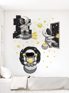 Space themed wall decals with astronauts and stars in a modern white bedroom setting
