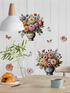 Close-up of vintage rose and butterfly wall stickers on a white wooden background