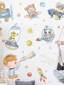 Detail showing hand-drawn cartoon animal astronauts and rocket wall decals for kids room