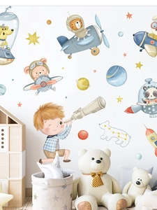 Detail of watercolor astronaut animal wall stickers on a clean white wall in a nursery