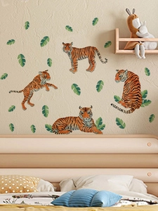 Realistic tiger wall stickers with tropical green leaves on a cozy bedroom wall