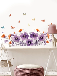 Detailed view of watercolor hibiscus wall stickers with colorful butterflies in a cozy room